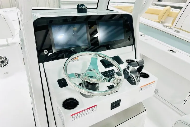 Slide: The Image of 2026 Sportsman Heritage 261 Center Console helm with dual screens and modern controls. - 3