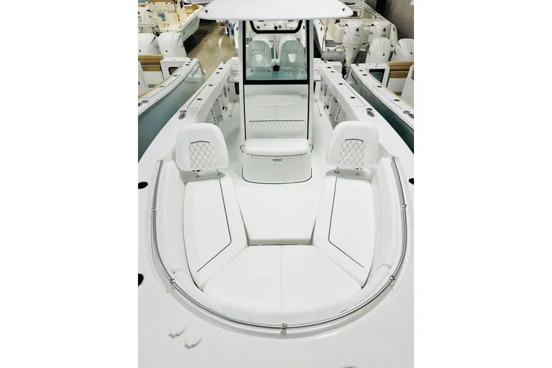 Slide: The Image of 2026 Sportsman Heritage 261 Center Console boat interior with white seating and modern design. - 4