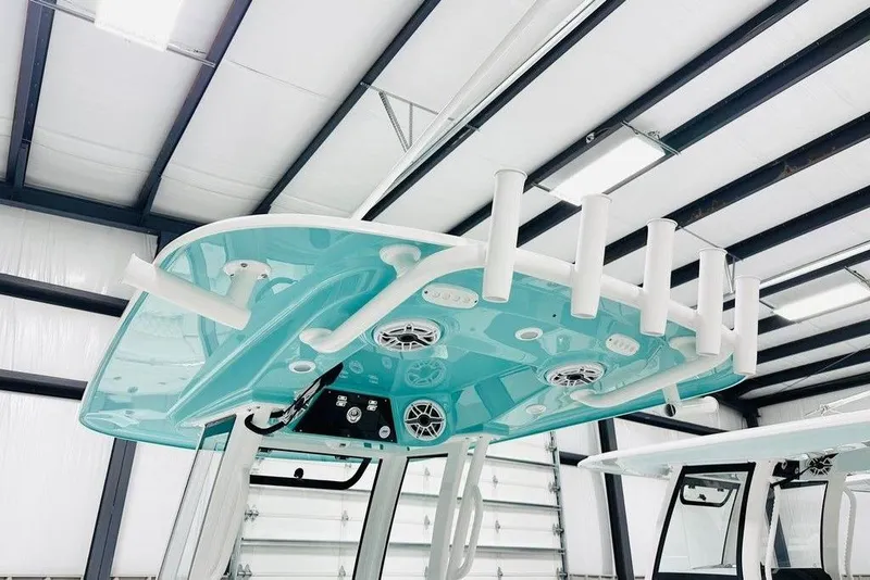 Slide: The Image of 2026 Sportsman Heritage 261 Center Console boat interior with rod holders and speakers. - 5