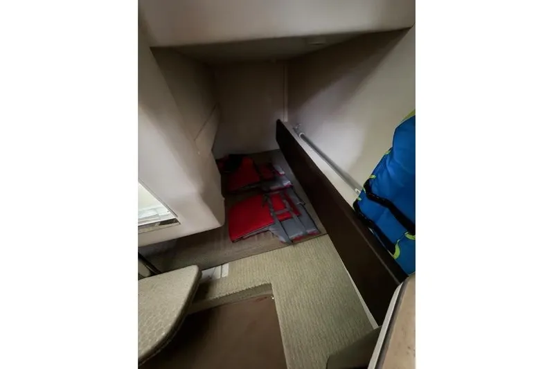 Slide: The Image of Interior cabin of 2018 Sea Ray Sundancer 260 with life jackets and storage space. - 16