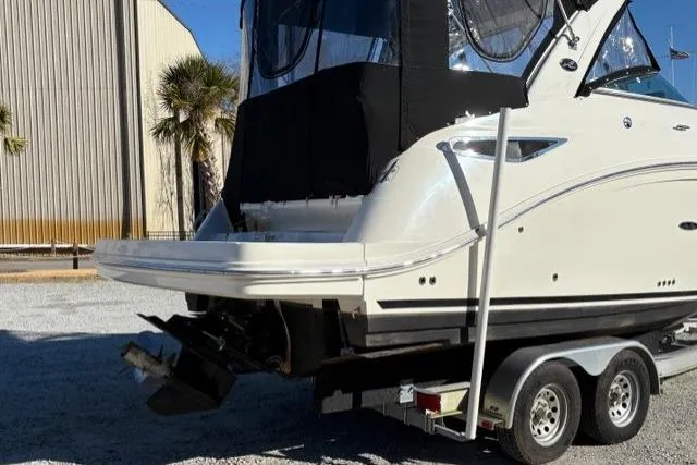 Slide: The Image of 2018 Sea Ray Sundancer 260 boat on trailer, rear view, parked outdoors. - 25