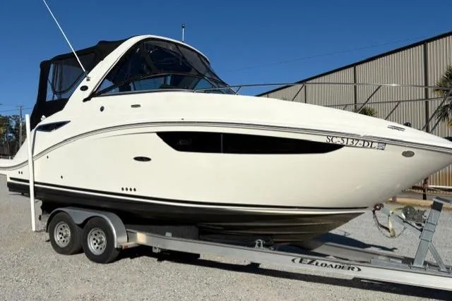 Slide: The Image of 2018 Sea Ray Sundancer 260 boat on trailer, parked outdoors. - 4
