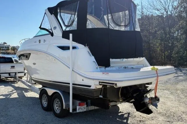 Slide: The Image of 2018 Sea Ray Sundancer 260 boat on trailer, covered, parked outdoors. - 6