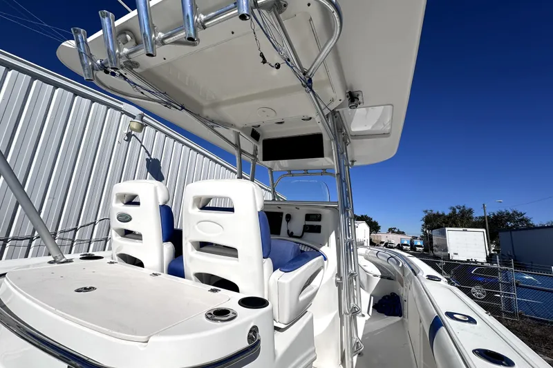 Slide: The Image of 2007 Boston Whaler 320 Outrage boat interior with seating and fishing rod holders. - 11