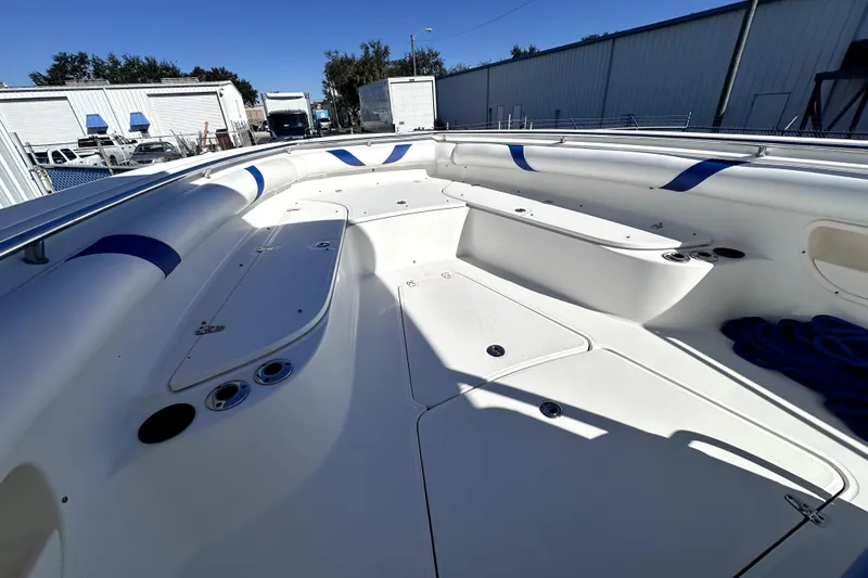 Slide: The Image of 2007 Boston Whaler 320 Outrage boat interior with white seating and blue accents. - 14