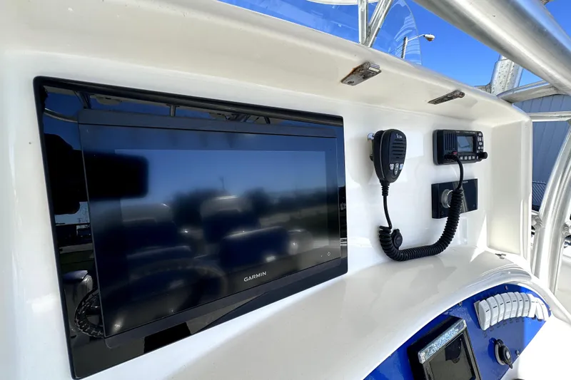 Slide: The Image of 2007 Boston Whaler 320 Outrage dashboard with Garmin display and communication equipment. - 22