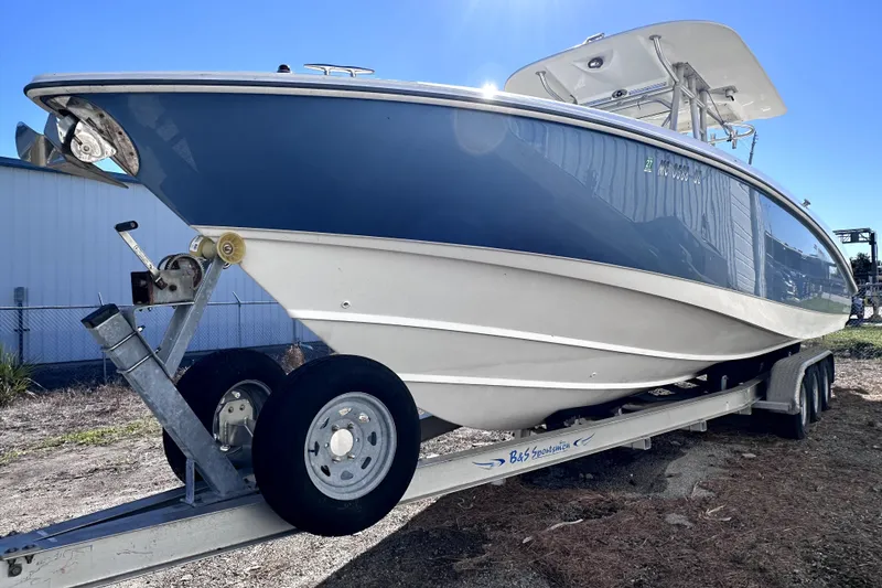 Slide: The Image of 2007 Boston Whaler 320 Outrage boat on trailer, side view, sunny day. - 3
