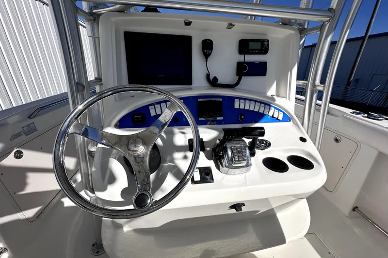 Slide: The Image of 2007 Boston Whaler 320 Outrage helm with steering wheel and control panel. - 8