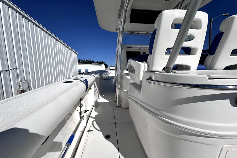 Slide: The Image of 2007 Boston Whaler 320 Outrage boat interior with white seating and blue accents. - 9