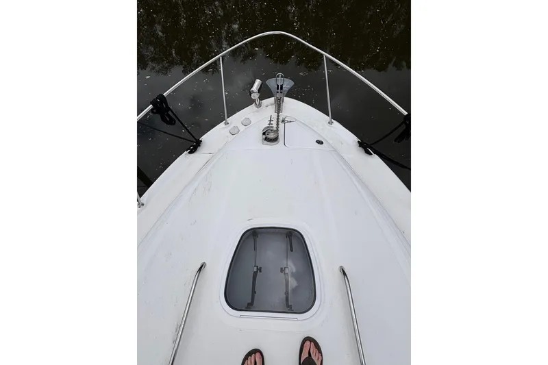 Slide: The Image of Bow view of 2003 Sea Ray 340 Sundancer yacht on calm water. - 21