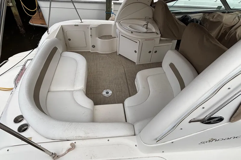 Slide: The Image of 2003 Sea Ray 340 Sundancer boat interior with seating and sink area. - 3