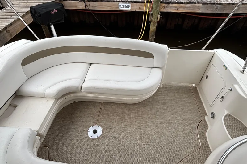 Slide: The Image of 2003 Sea Ray 340 Sundancer boat interior with white seating and carpeted floor. - 4