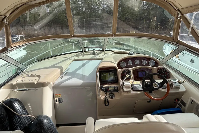 Slide: The Image of 2003 Sea Ray 340 Sundancer helm with navigation instruments and steering wheel. - 9