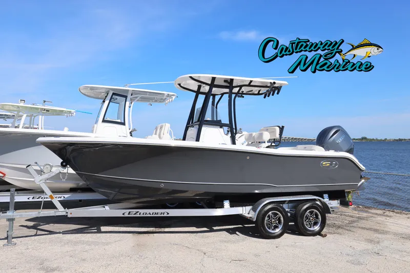 The Image of 2026 Sea Hunt Ultra 219 boat on trailer by Castaway Marine, near water. - 0