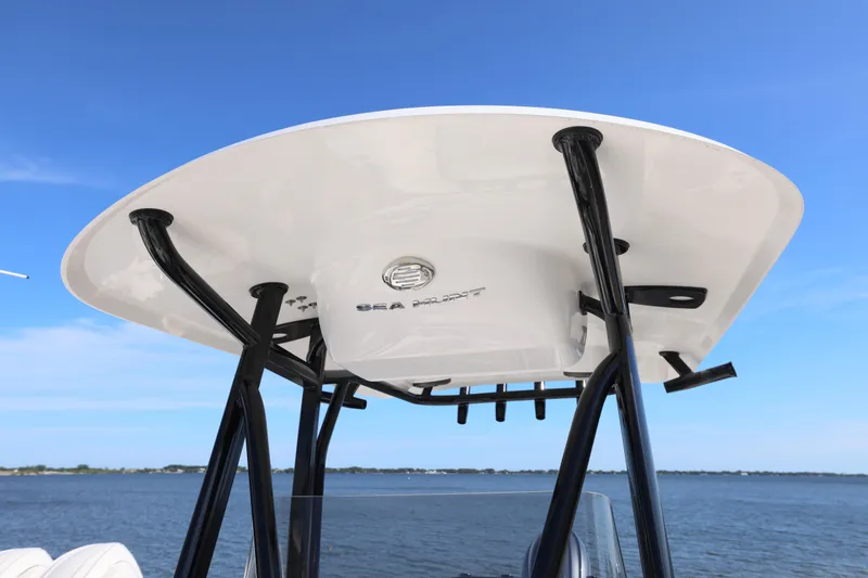 Slide: The Image of 2026 Sea Hunt Ultra 219 boat T-top against clear blue sky. - 11