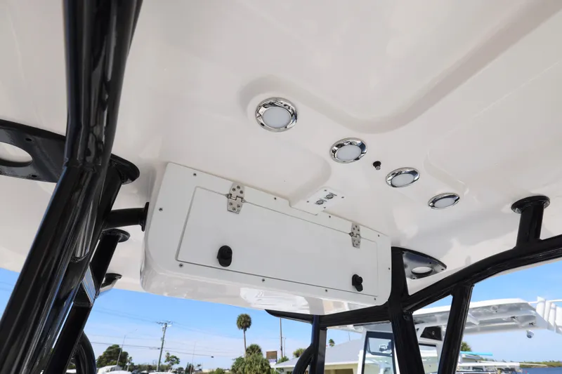 Slide: The Image of 2026 Sea Hunt Ultra 219 boat interior ceiling with lights and storage compartment. - 15