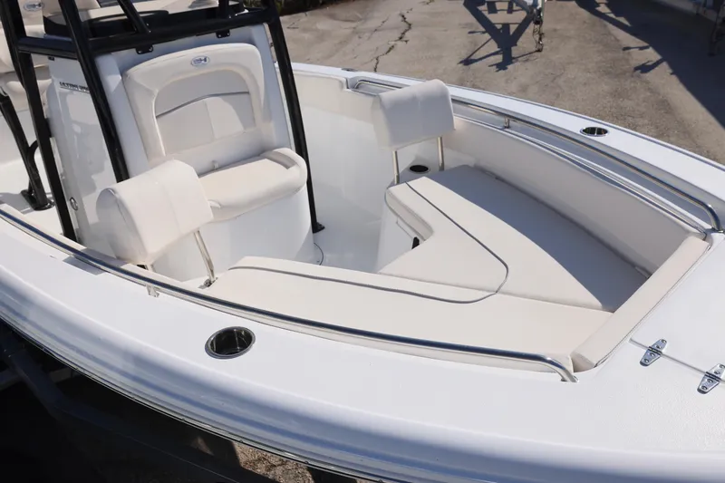 Slide: The Image of 2026 Sea Hunt Ultra 219 boat interior with white seating and stainless steel railings. - 2