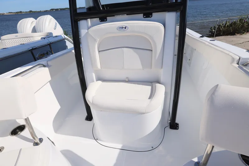 Slide: The Image of 2026 Sea Hunt Ultra 219 boat interior with white seating and ocean view. - 6