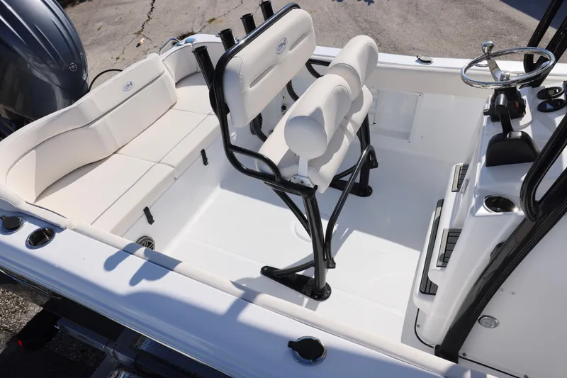 Slide: The Image of 2026 Sea Hunt Ultra 219 boat interior with white seating and steering console. - 8