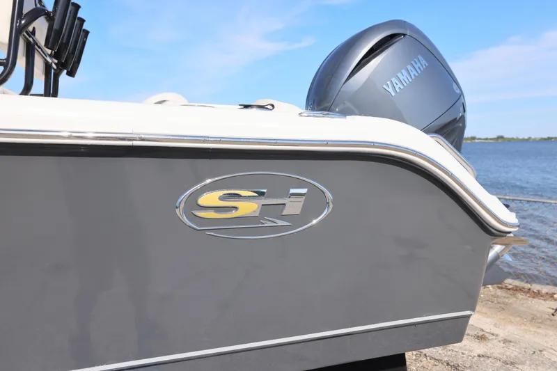 Slide: The Image of 2026 Sea Hunt Ultra 219 boat with Yamaha engine by the water. - 9