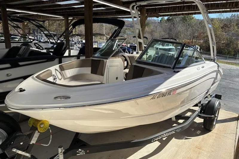 The Image of 2021 Chaparral 19 SSi boat on trailer in covered storage area. - 1
