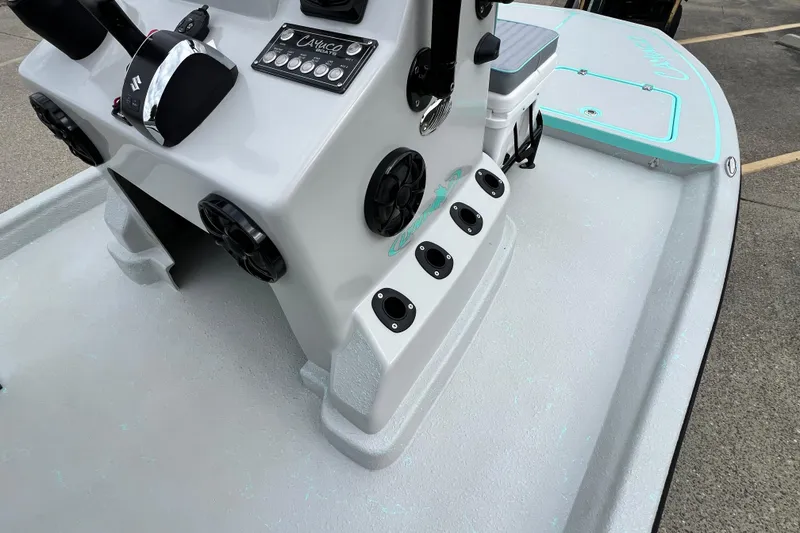 Slide: The Image of 2026 Cayuco Boats Lynx 18 console with controls and speakers on deck. - 11