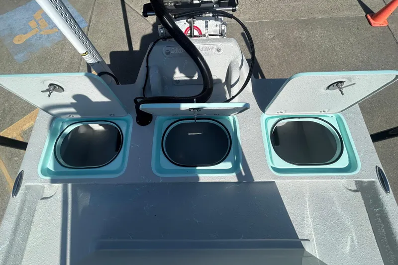 Slide: The Image of Cayuco Boats Lynx 18 (2026) with open storage compartments on deck. - 17