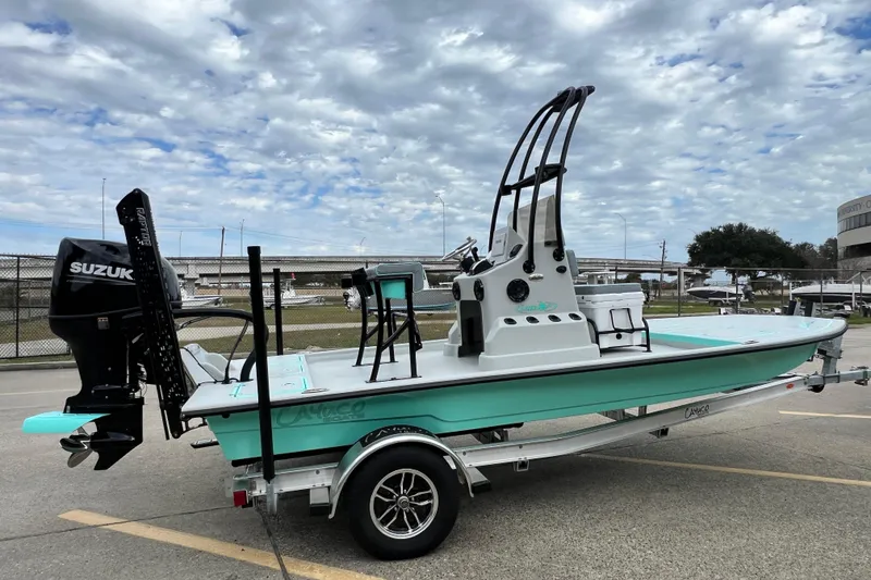 Slide: The Image of 2026 Cayuco Boats Lynx 18 on trailer, featuring Suzuki outboard motor, under cloudy sky. - 3