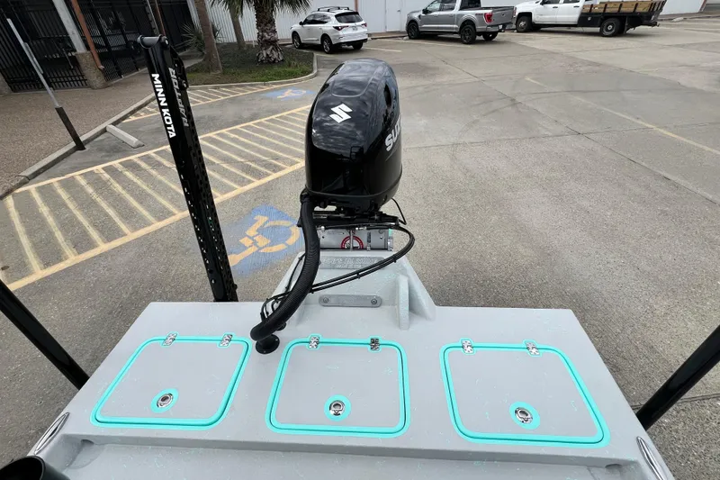 Slide: The Image of Cayuco Boats Lynx 18, 2026 model, with Suzuki outboard motor in parking lot. - 7