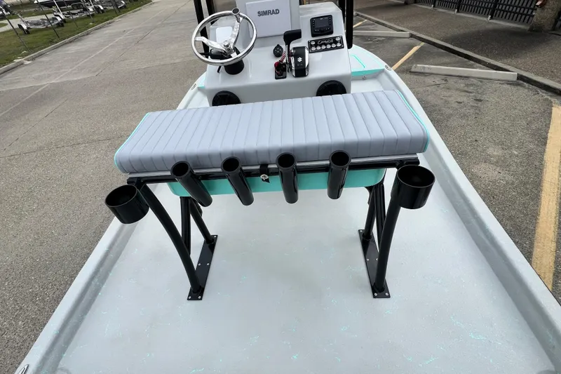 Slide: The Image of 2026 Cayuco Boats Lynx 18 with rod holders and steering console on a trailer. - 9