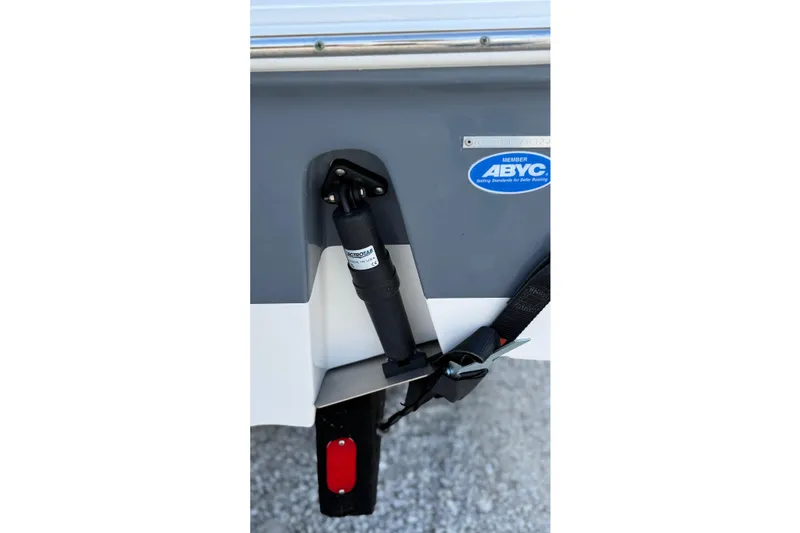 Slide: The Image of 2023 Tidewater 220 LXF boat with ABYC certification sticker and trim tab detail. - 12
