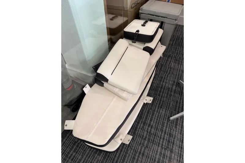 Slide: The Image of 2023 Tidewater 220 LXF boat seat cushions stacked indoors. - 14