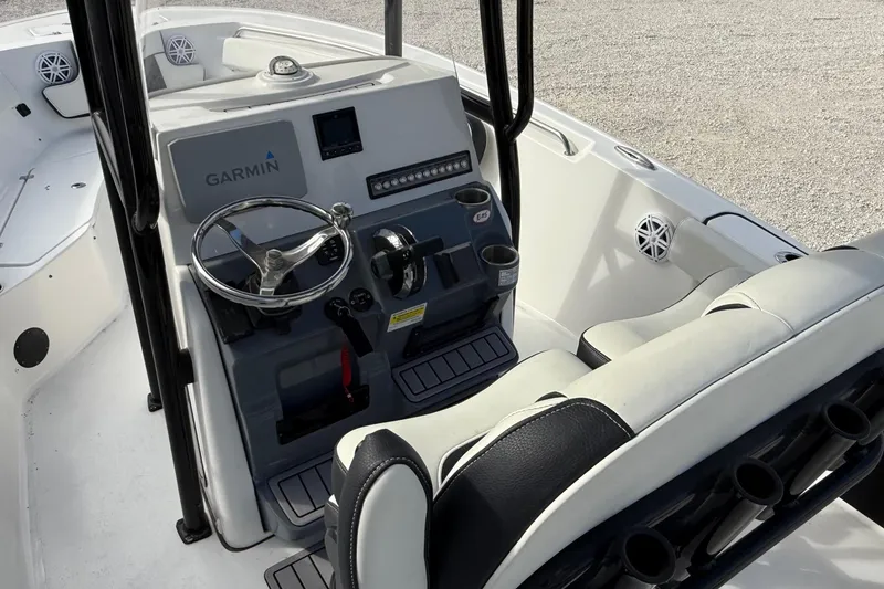 Slide: The Image of 2023 Tidewater 220 LXF boat interior with Garmin navigation system and sleek seating. - 15