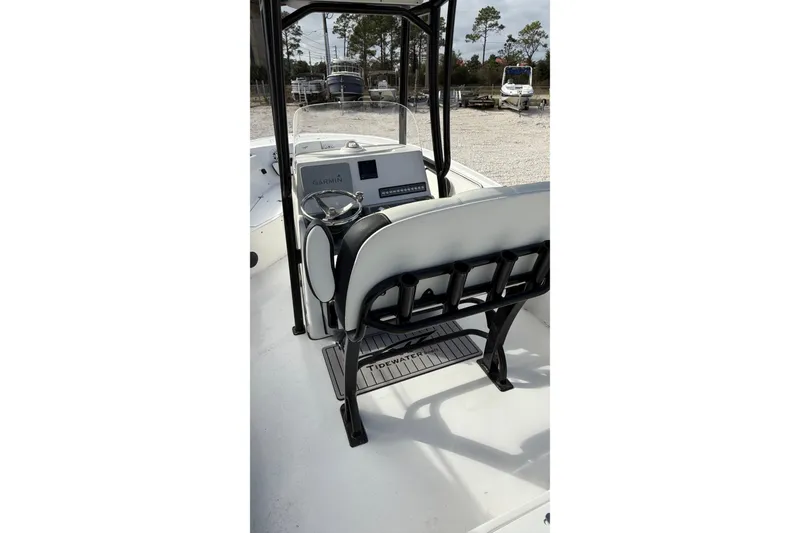 Slide: The Image of 2023 Tidewater 220 LXF boat interior with steering console and seating. - 16