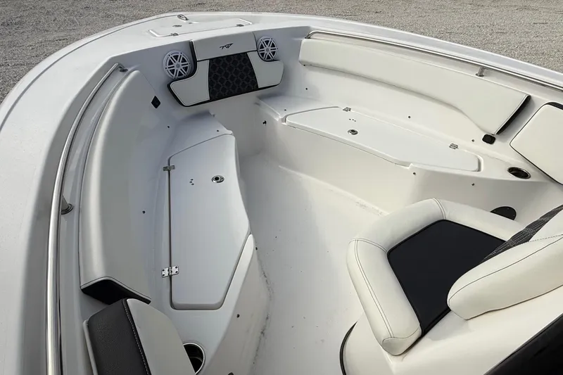 Slide: The Image of 2023 Tidewater 220 LXF boat interior with white seating and storage compartments. - 17