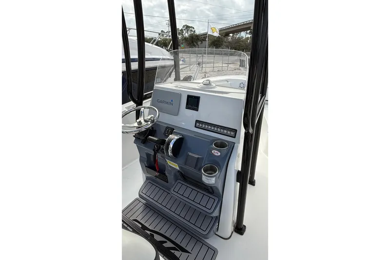 Slide: The Image of 2023 Tidewater 220 LXF boat console with Garmin navigation and cup holders. - 19