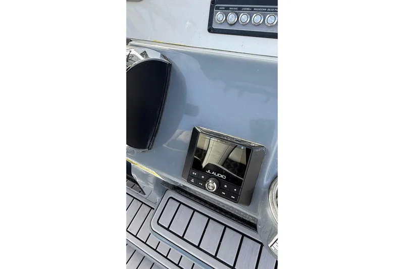 Slide: The Image of Control panel of 2023 Tidewater 220 LXF boat featuring JL Audio system. - 22