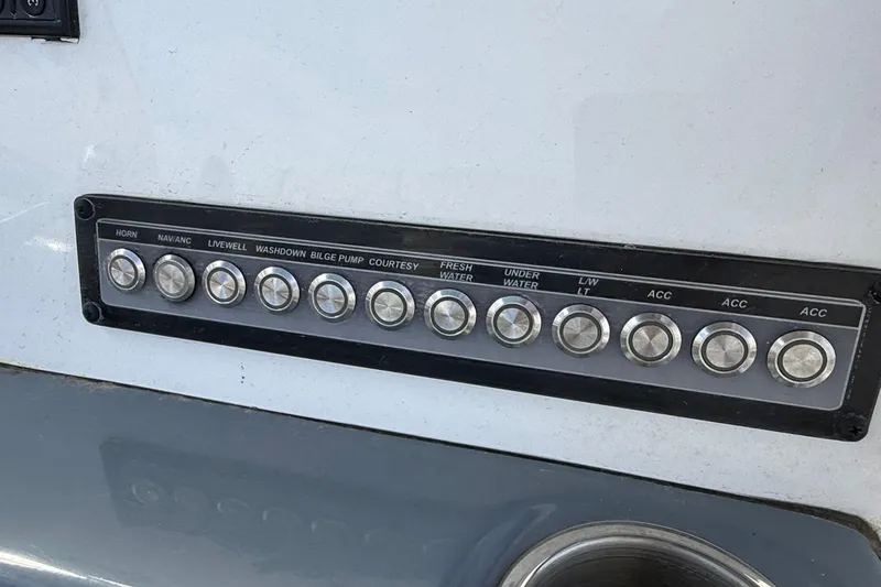 Slide: The Image of Control panel of 2023 Tidewater 220 LXF boat with labeled buttons. - 23