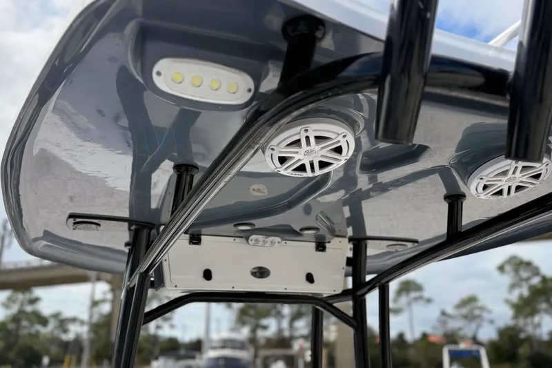 Slide: The Image of 2023 Tidewater 220 LXF boat T-top with speakers and LED lights. - 24