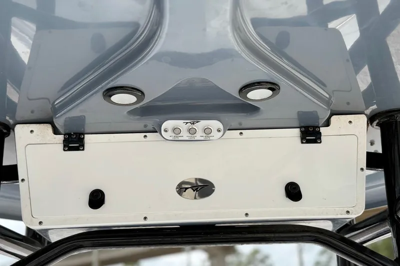 Slide: The Image of 2023 Tidewater 220 LXF boat console with controls and storage compartment. - 25