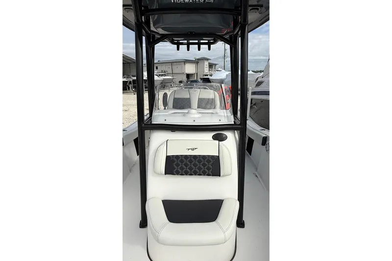 Slide: The Image of 2023 Tidewater 220 LXF boat interior with cushioned seating and sleek design. - 29