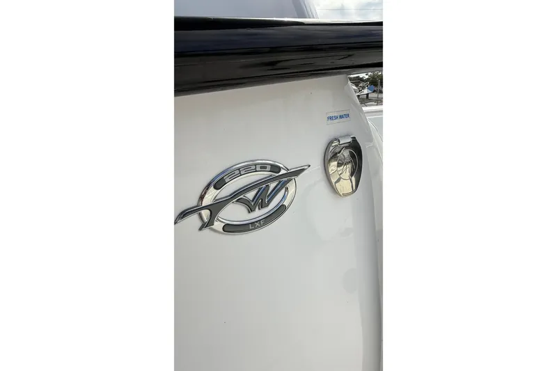 Slide: The Image of 2023 Tidewater 220 LXF boat emblem and fresh water port. - 35