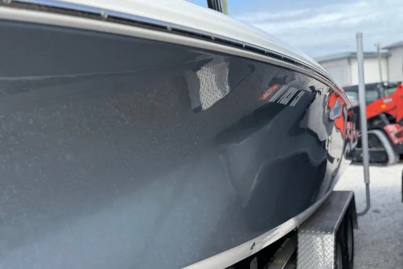 Slide: The Image of 2023 Tidewater 220 LXF boat hull on trailer, showcasing sleek design and glossy finish. - 4