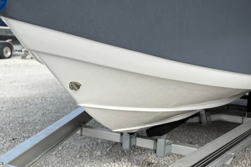 Slide: The Image of 2023 Tidewater 220 LXF boat hull on trailer, close-up view. - 5