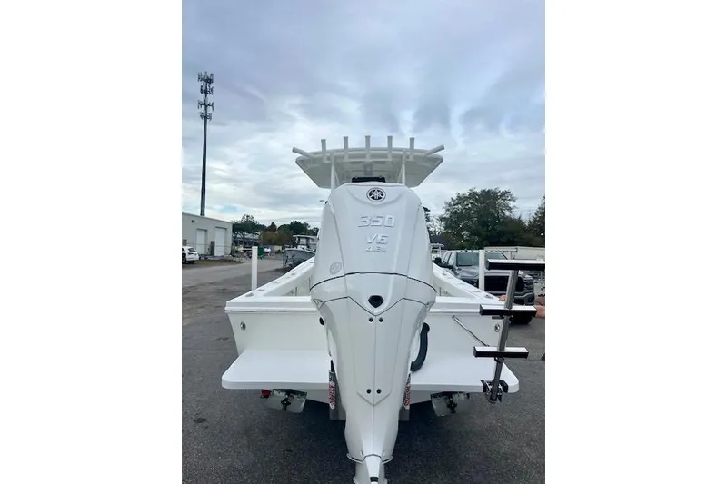 Slide: The Image of 2026 Pair Customs 24 Center Console MV with powerful 350 V8 engine, rear view. - 2