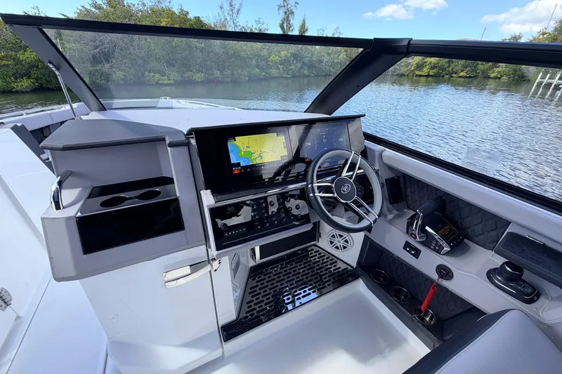 Slide: The Image of 2026 Cobalt R35 Outboard boat dashboard with modern navigation system and steering wheel. - 13