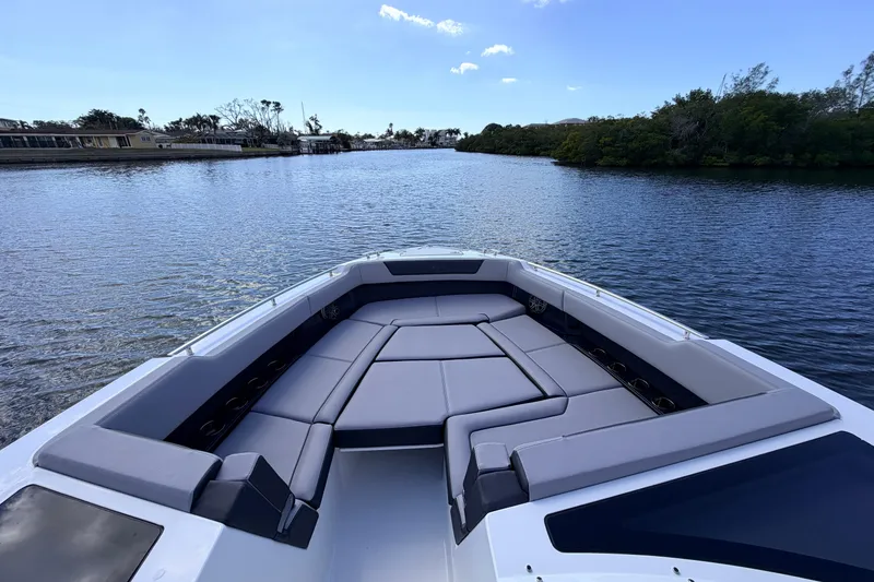 Slide: The Image of 2026 Cobalt R35 Outboard boat with spacious seating on a serene waterway. - 15