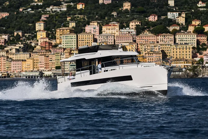 Slide: The Image of 2025 Northman 1300 yacht cruising near colorful coastal buildings. - 25