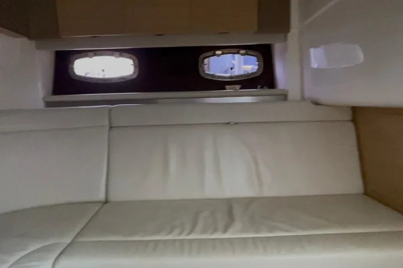 Slide: The Image of Interior cabin of 2013 Chaparral 327 SSX with white seating and porthole windows. - 11