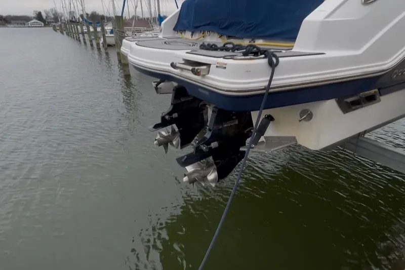 Slide: The Image of 2013 Chaparral 327 SSX boat with dual propellers docked at marina. - 14